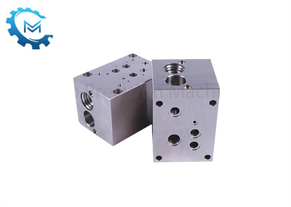 What are the functions of each port in the hydraulic valve block?